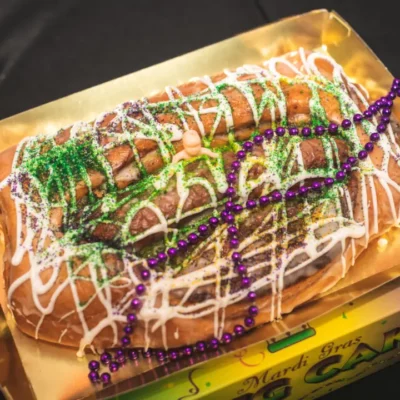 A Mardi Gras King Cake with purple beads